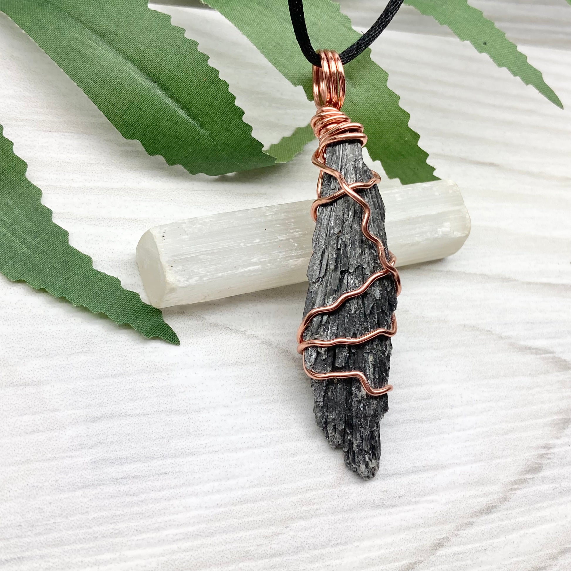 Black Kyanite necklace. Real raw Black Kyanite wrapped with tarnish resistant copper wire. Hangs on a black chain. Wire wrapped black crystal pendant. Spiritual gift.