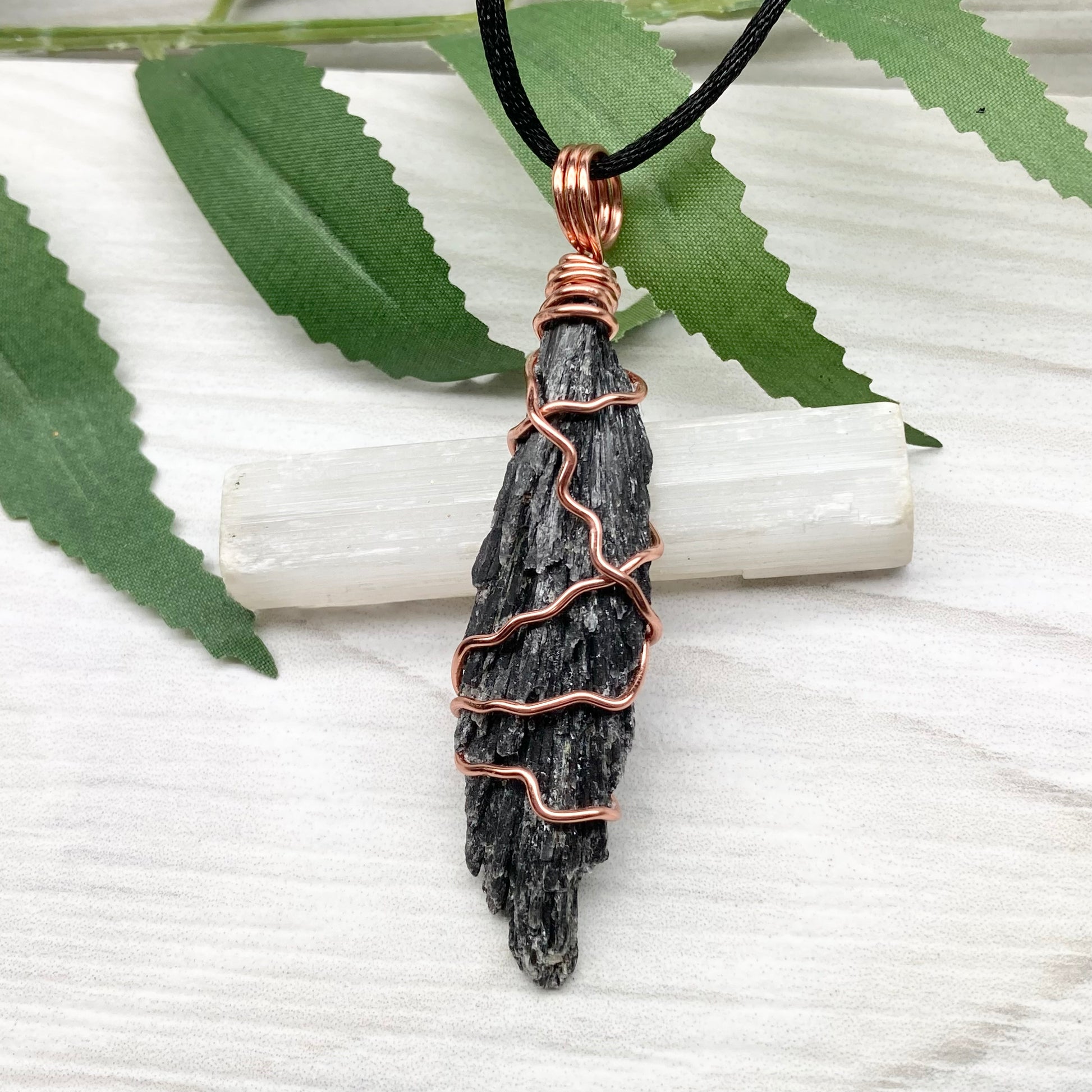 Black Kyanite necklace. Real raw Black Kyanite wrapped with tarnish resistant copper wire. Hangs on a black chain. Wire wrapped black crystal pendant. Spiritual gift.