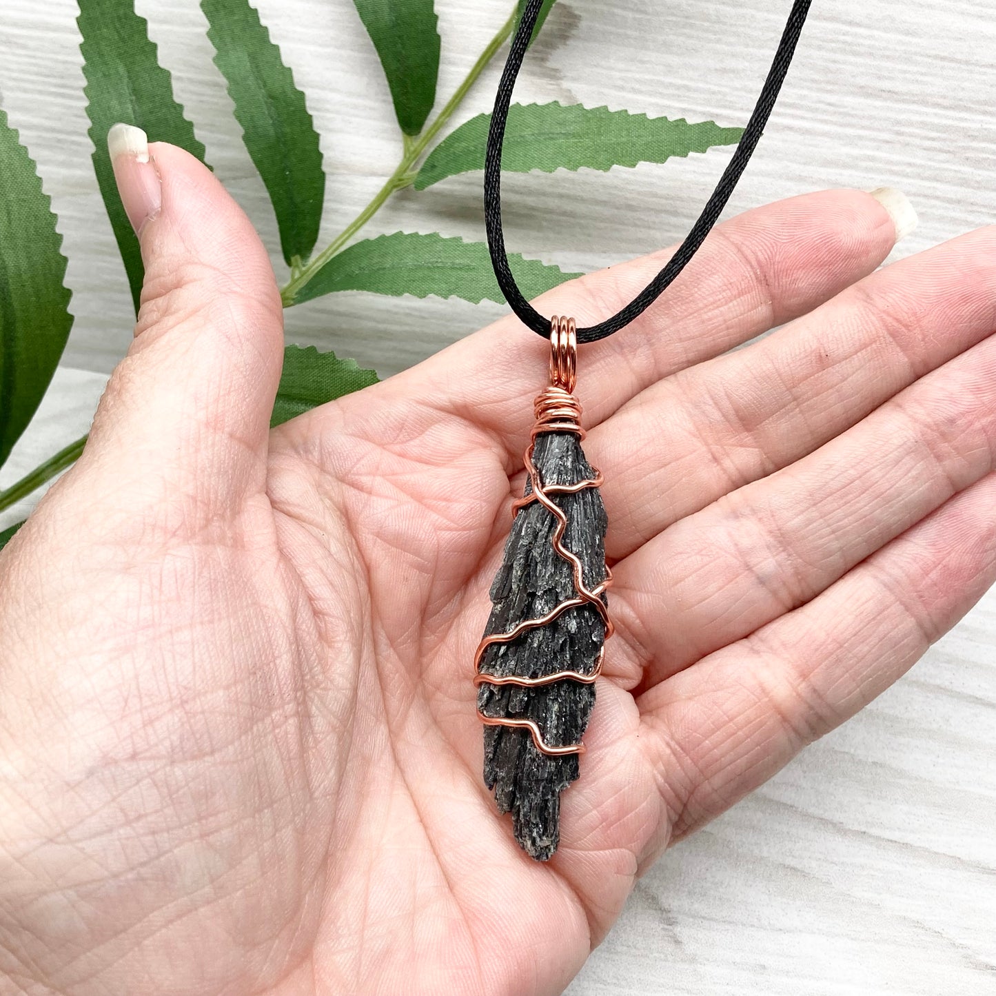 Black Kyanite necklace. Real raw Black Kyanite wrapped with tarnish resistant copper wire. Hangs on a black chain. Wire wrapped black crystal pendant. Spiritual gift.