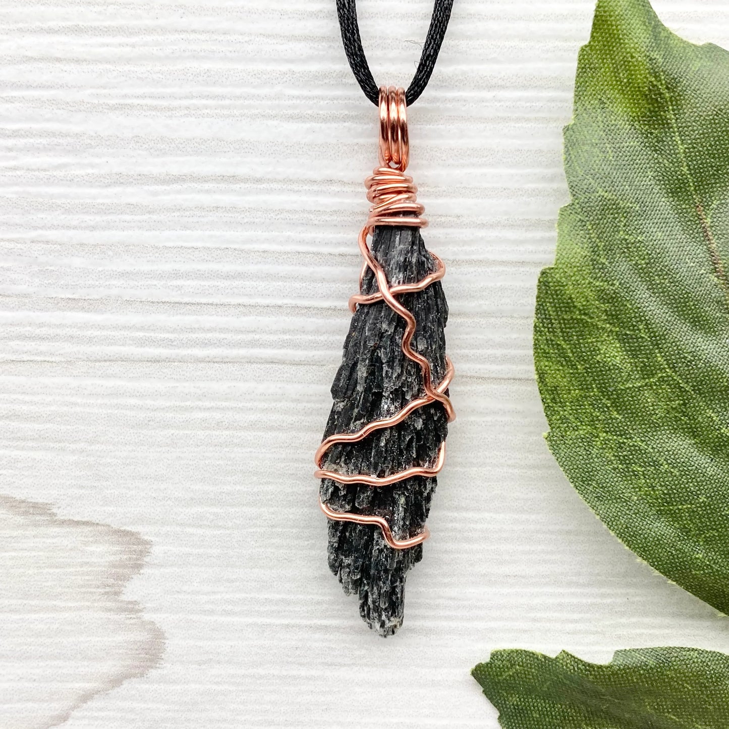 Black Kyanite necklace. Real raw Black Kyanite wrapped with tarnish resistant copper wire. Hangs on a black chain. Wire wrapped black crystal pendant. Spiritual gift.