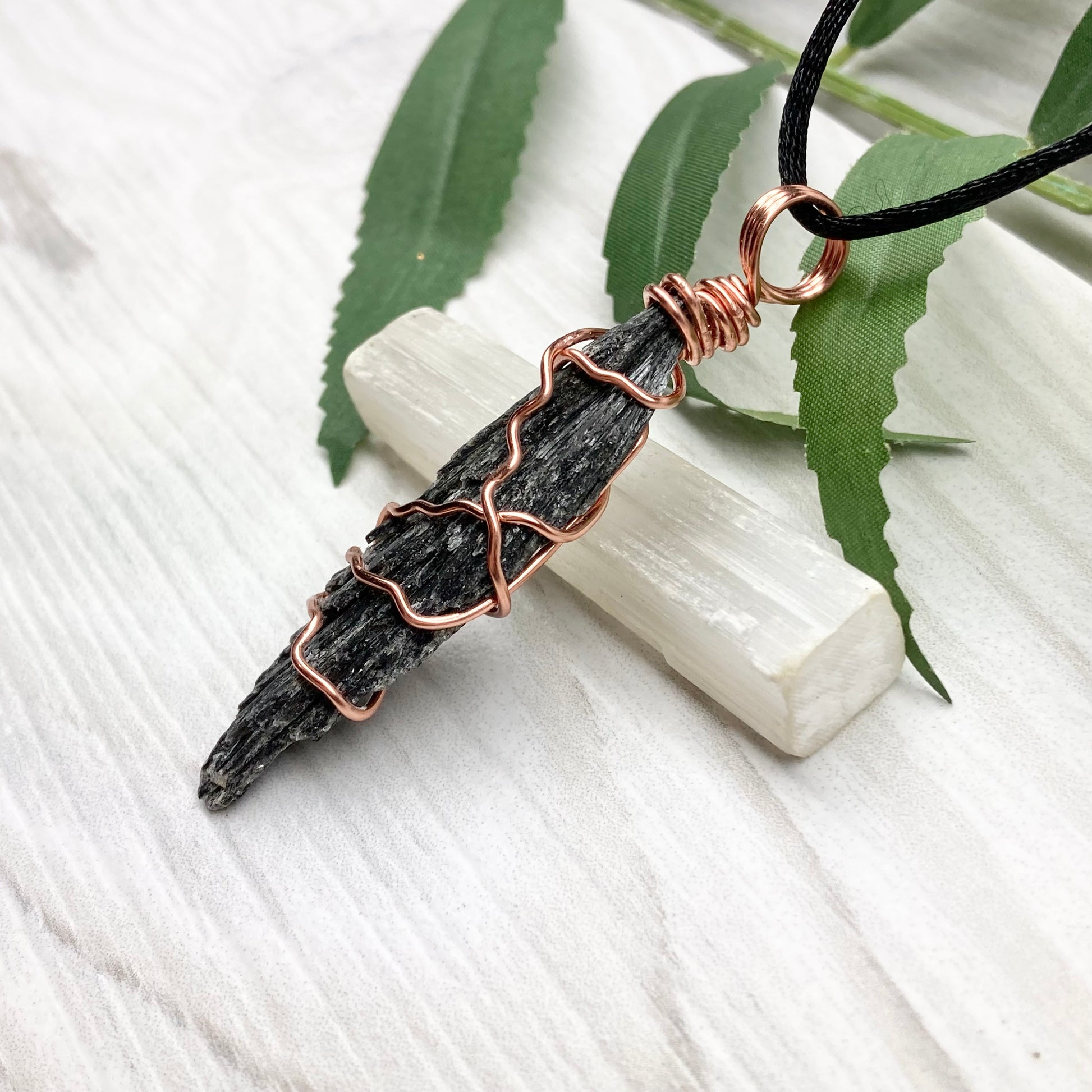 Black Kyanite necklace. Real raw Black Kyanite wrapped with tarnish resistant copper wire. Hangs on a black chain. Wire wrapped black crystal pendant. Spiritual gift.