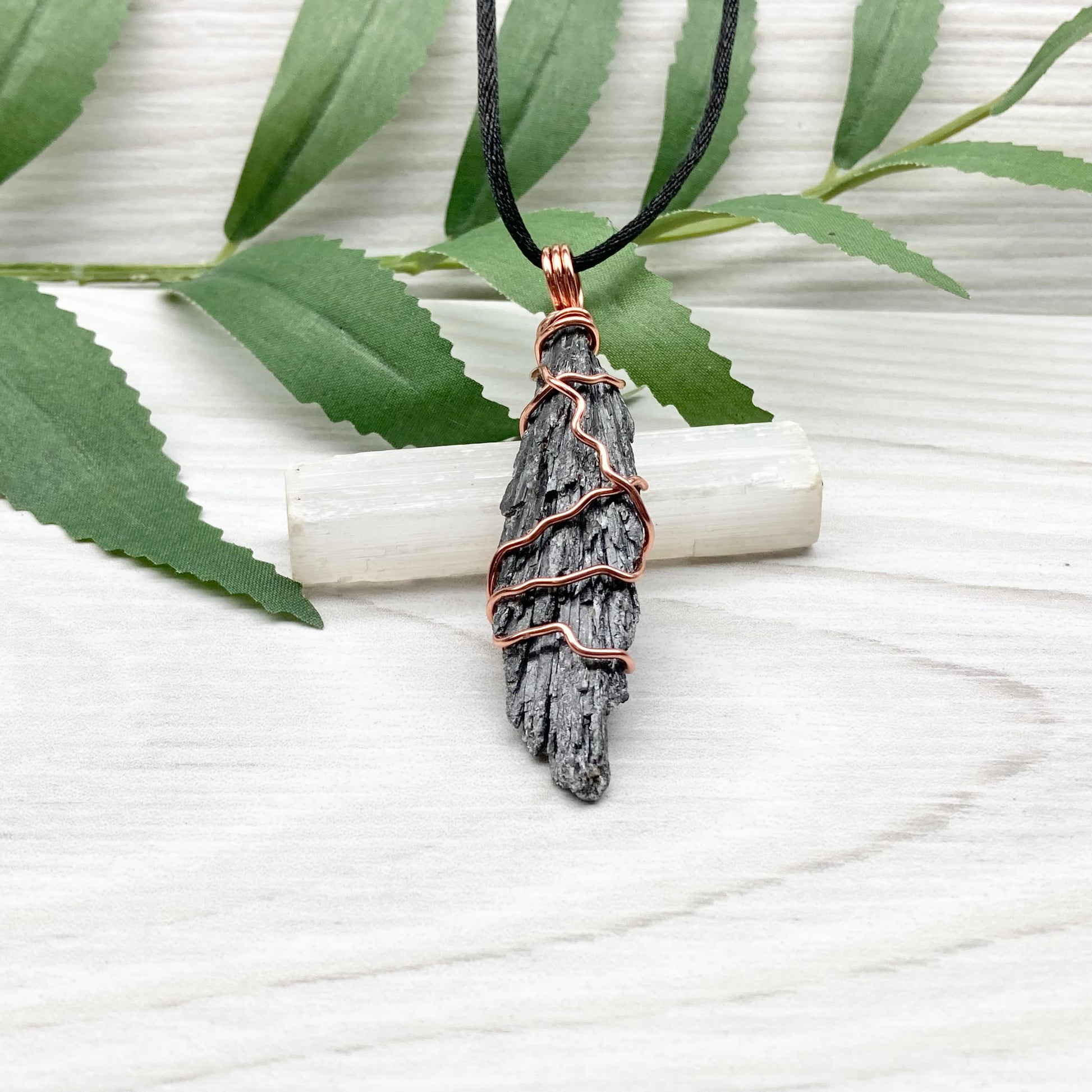 Black Kyanite necklace. Real raw Black Kyanite wrapped with tarnish resistant copper wire. Hangs on a black chain. Wire wrapped black crystal pendant. Spiritual gift.