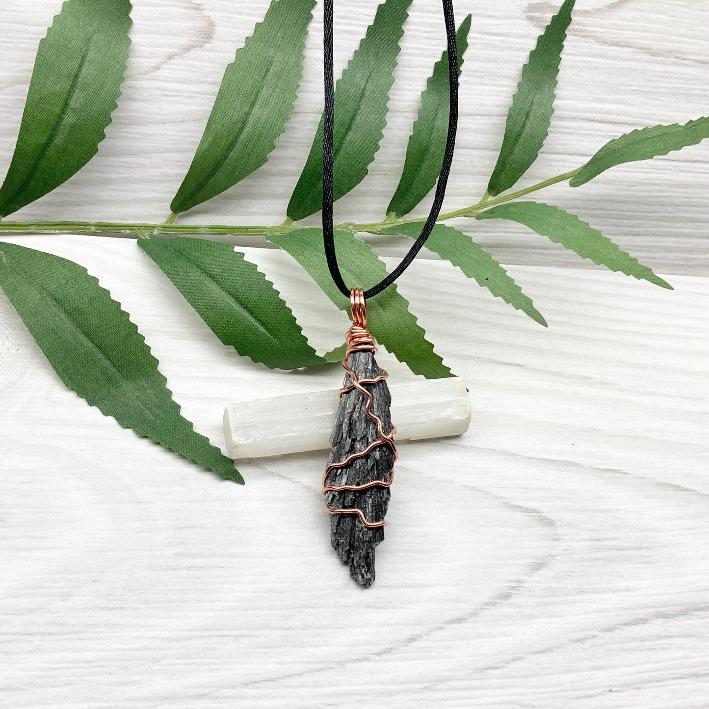 Black Kyanite necklace. Real raw Black Kyanite wrapped with tarnish resistant copper wire. Hangs on a black chain. Wire wrapped black crystal pendant. Spiritual gift.