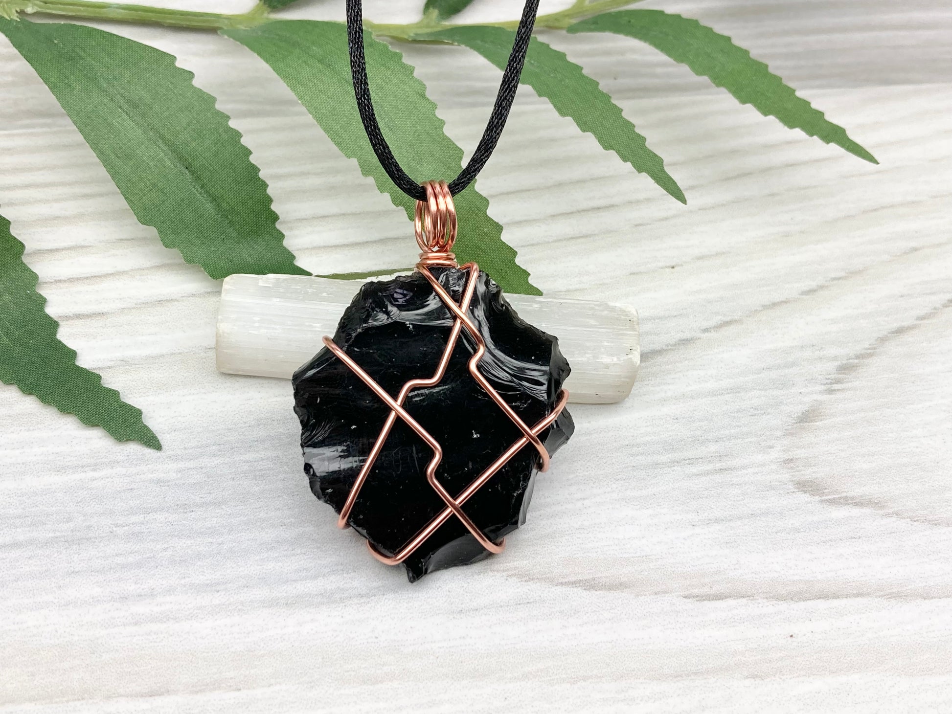 Raw black obsidian necklace. Natural black crystal wrapped with copper wire. Comes on a black necklace.