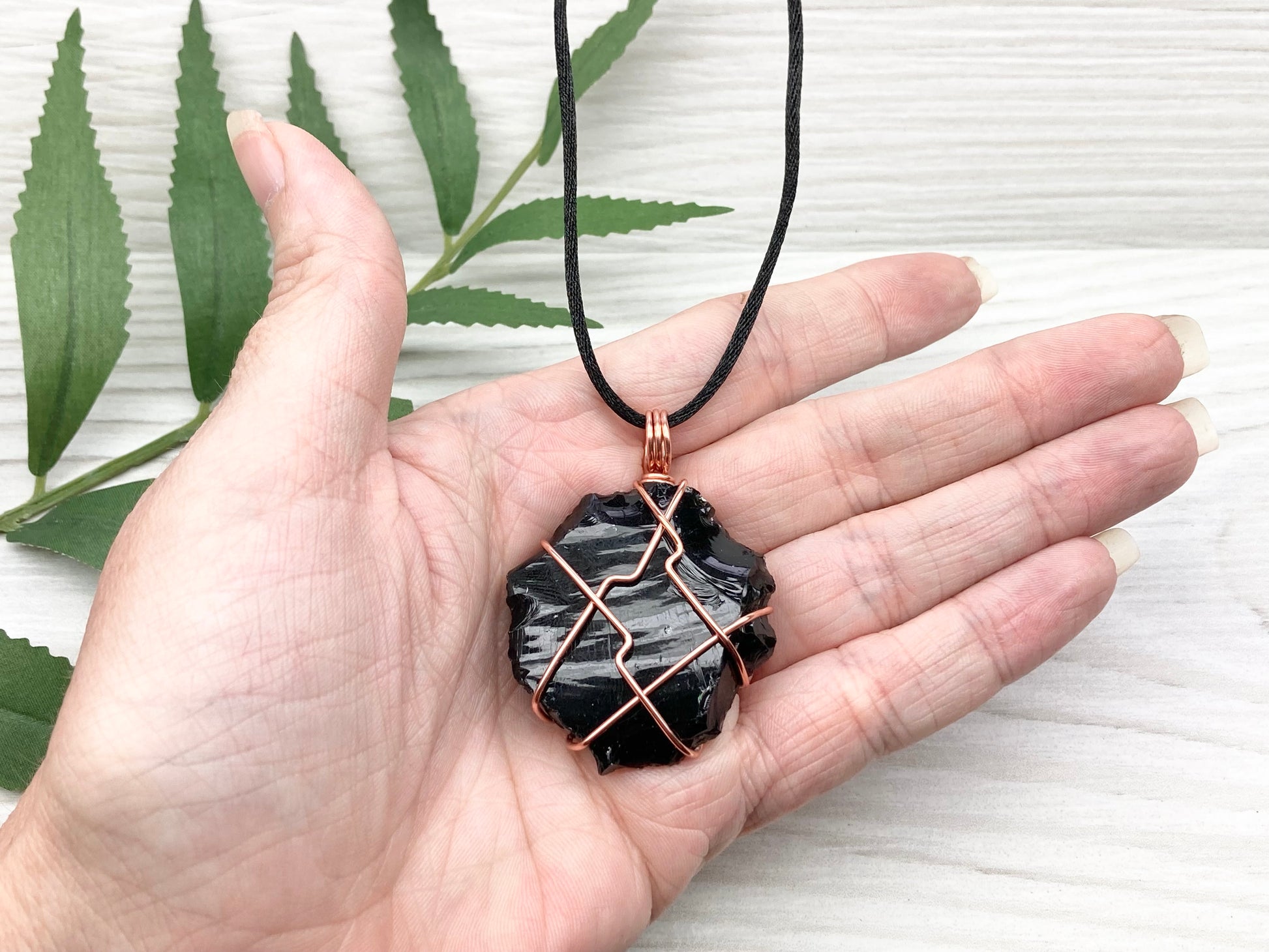 Raw black obsidian necklace. Natural black crystal wrapped with copper wire. Comes on a black necklace.