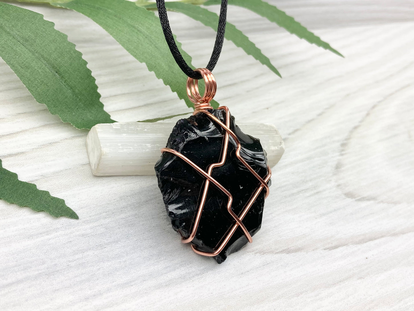 Raw black obsidian necklace. Natural black crystal wrapped with copper wire. Comes on a black necklace.