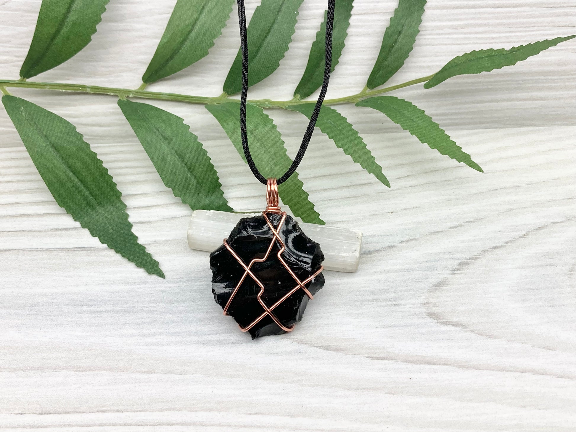 Raw black obsidian necklace. Natural black crystal wrapped with copper wire. Comes on a black necklace.