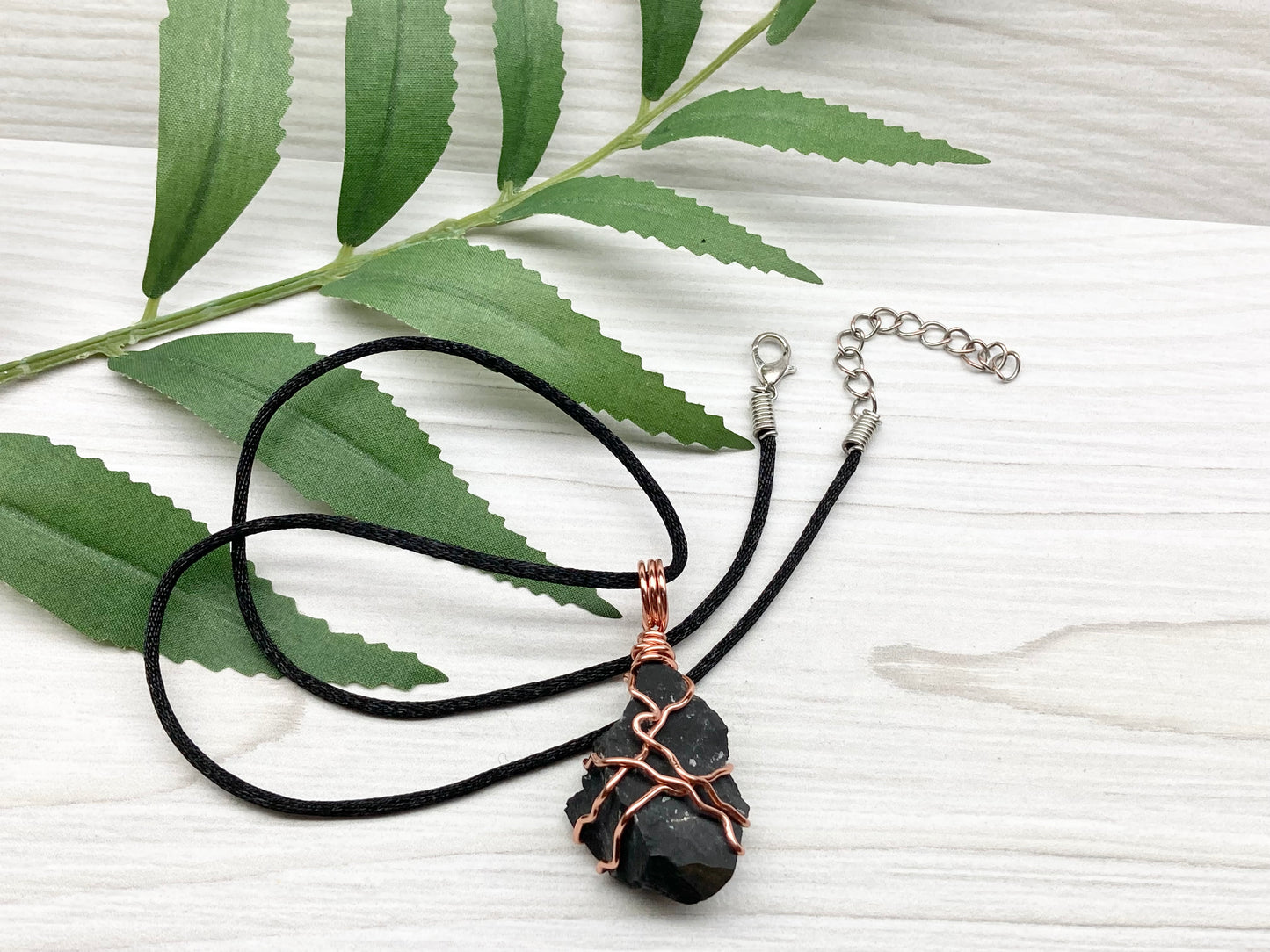 Black Onyx necklace. Raw Onyx wrapped with tarnish resistant copper wire. Comes on a black chain. Black stone wire wrapped pendant. 