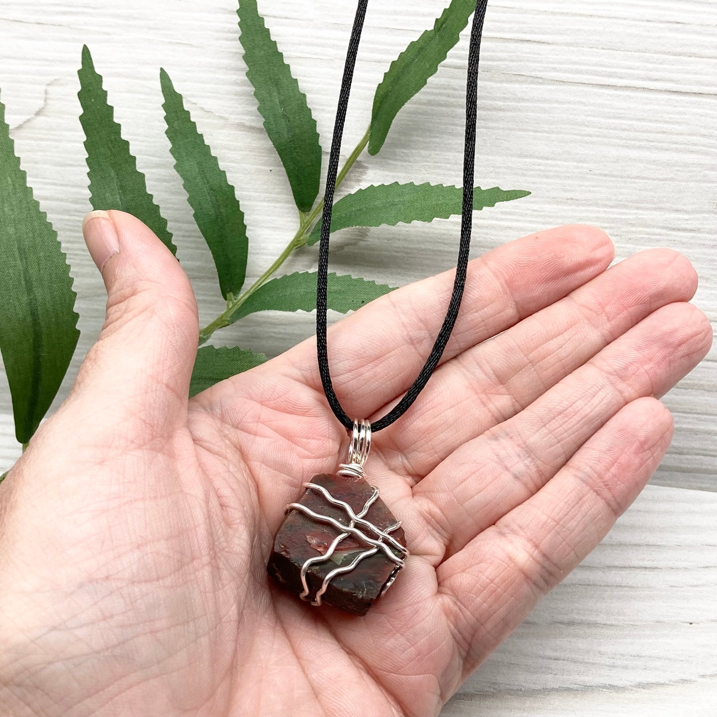 Fancy Jasper necklace. Raw Fancy Jasper stone wrapped with silver colored copper wire. Comes on a black chain. Wire wrapped crystal pendant. Green and red gemstone. Aries zodiac jewelry.