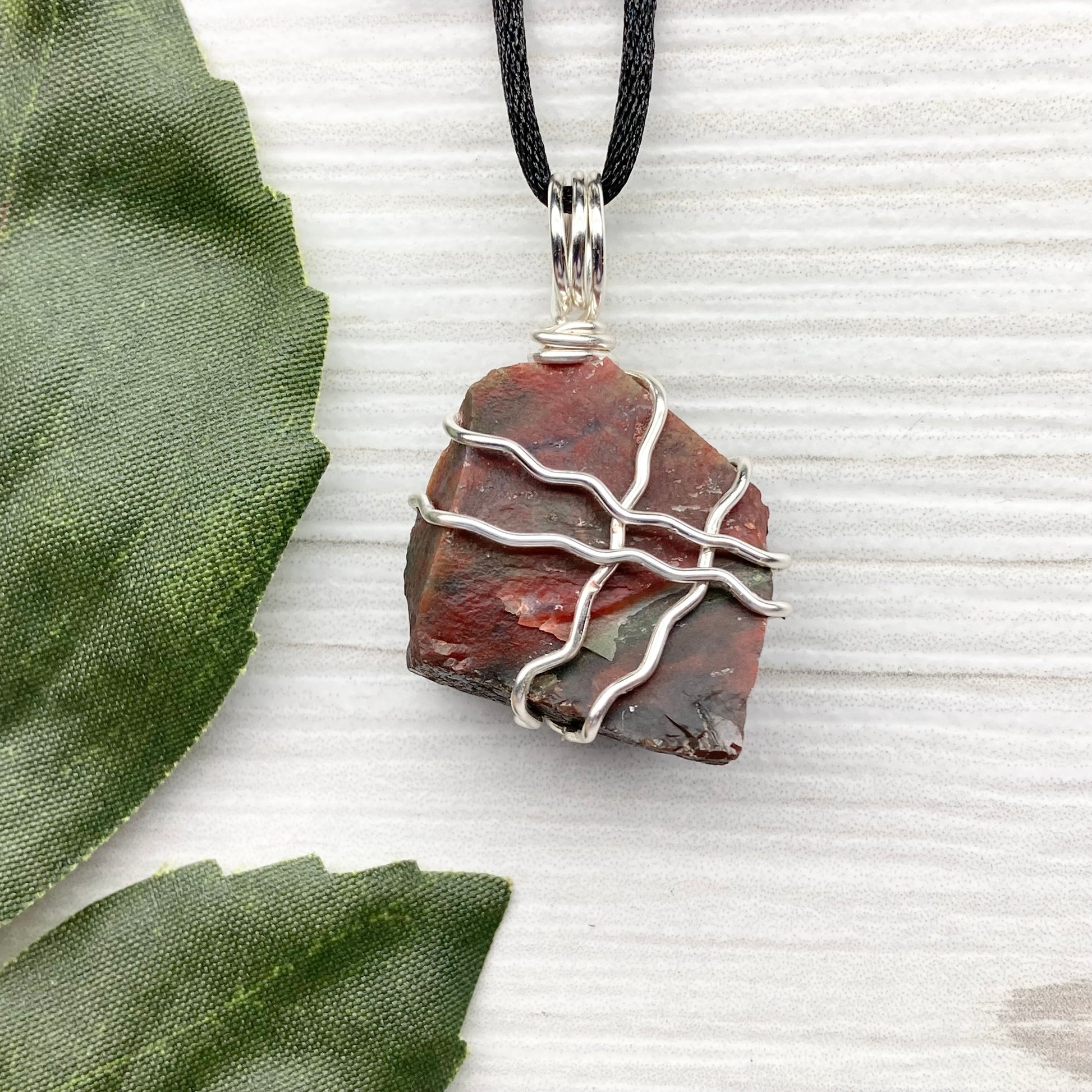 Fancy Jasper necklace. Raw Fancy Jasper stone wrapped with silver colored copper wire. Comes on a black chain. Wire wrapped crystal pendant. Green and red gemstone. Aries zodiac jewelry.