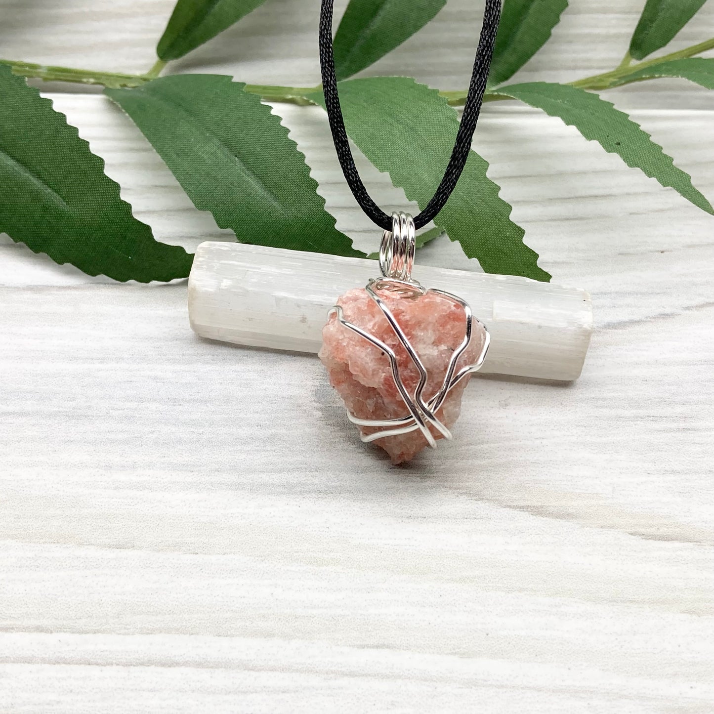 Sunstone Necklace. Raw Sunstone wrapped with silver copper wire. Comes on a black chain. Wire wrapped crystal pendant. Peachy stone jewelry.