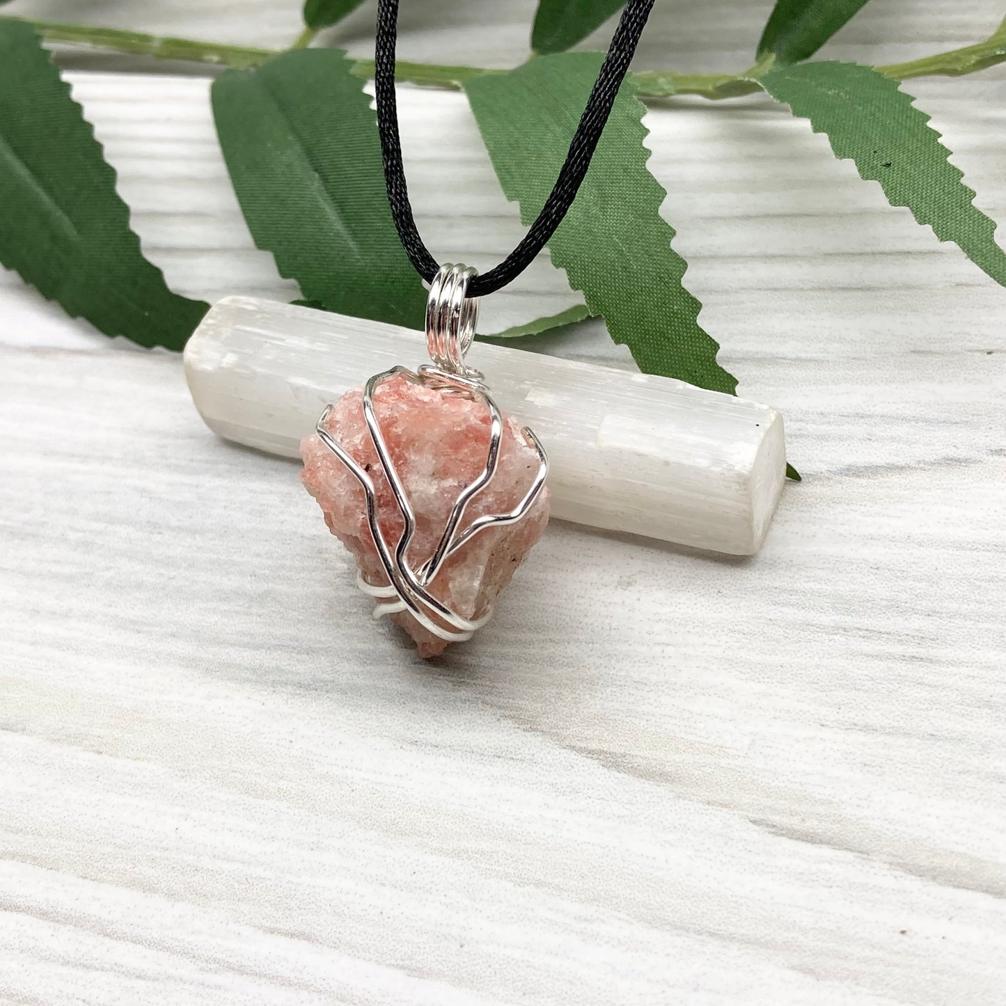 Sunstone Necklace. Raw Sunstone wrapped with silver copper wire. Comes on a black chain. Wire wrapped crystal pendant. Peachy stone jewelry.