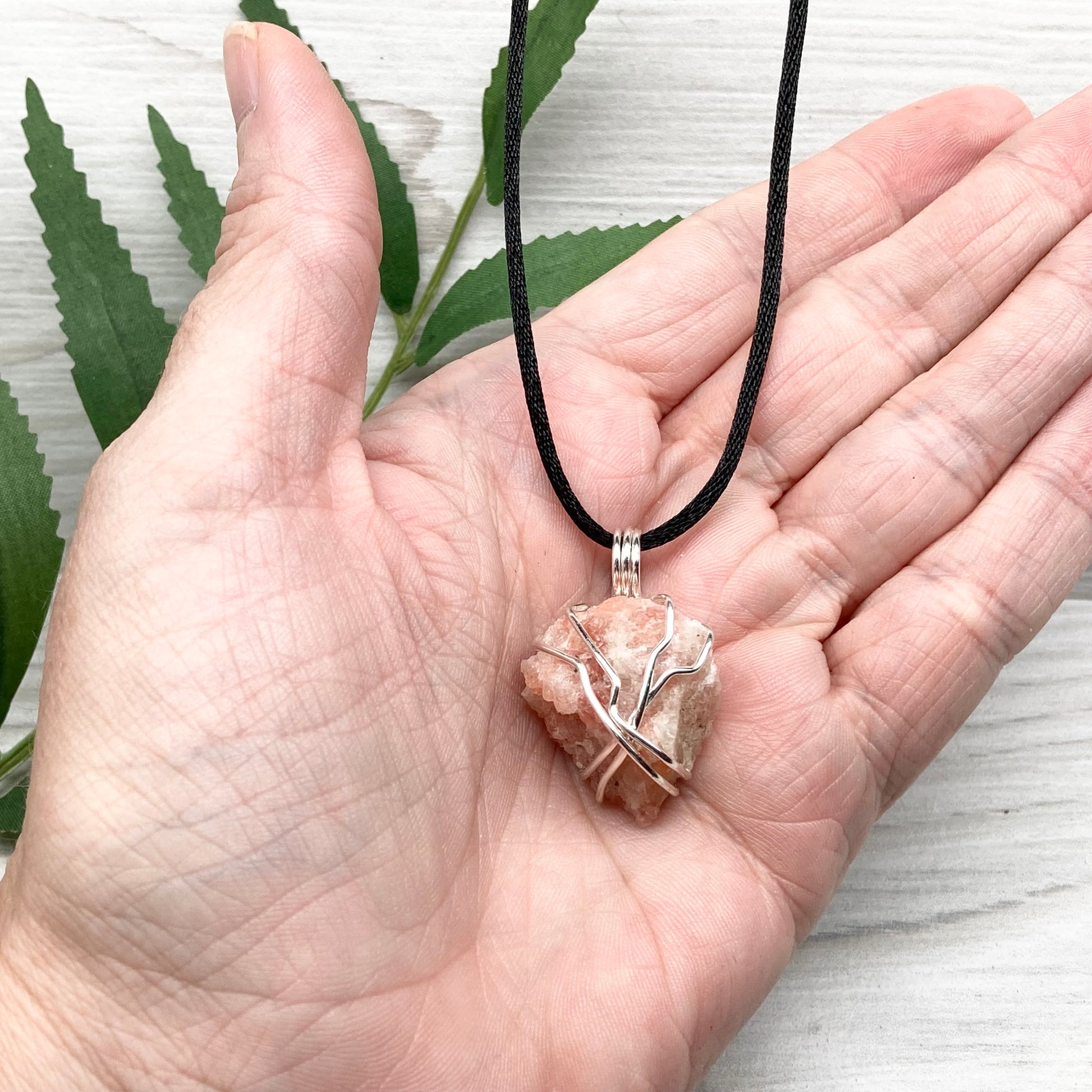 Sunstone Necklace. Raw Sunstone wrapped with silver copper wire. Comes on a black chain. Wire wrapped crystal pendant. Peachy stone jewelry.