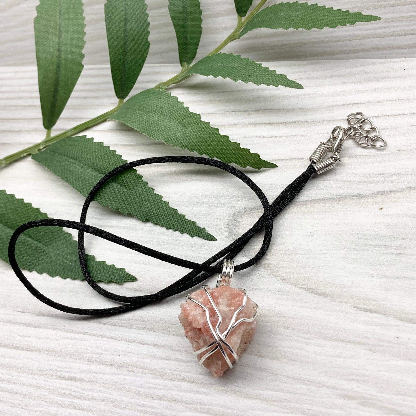 Sunstone Necklace. Raw Sunstone wrapped with silver copper wire. Comes on a black chain. Wire wrapped crystal pendant. Peachy stone jewelry.