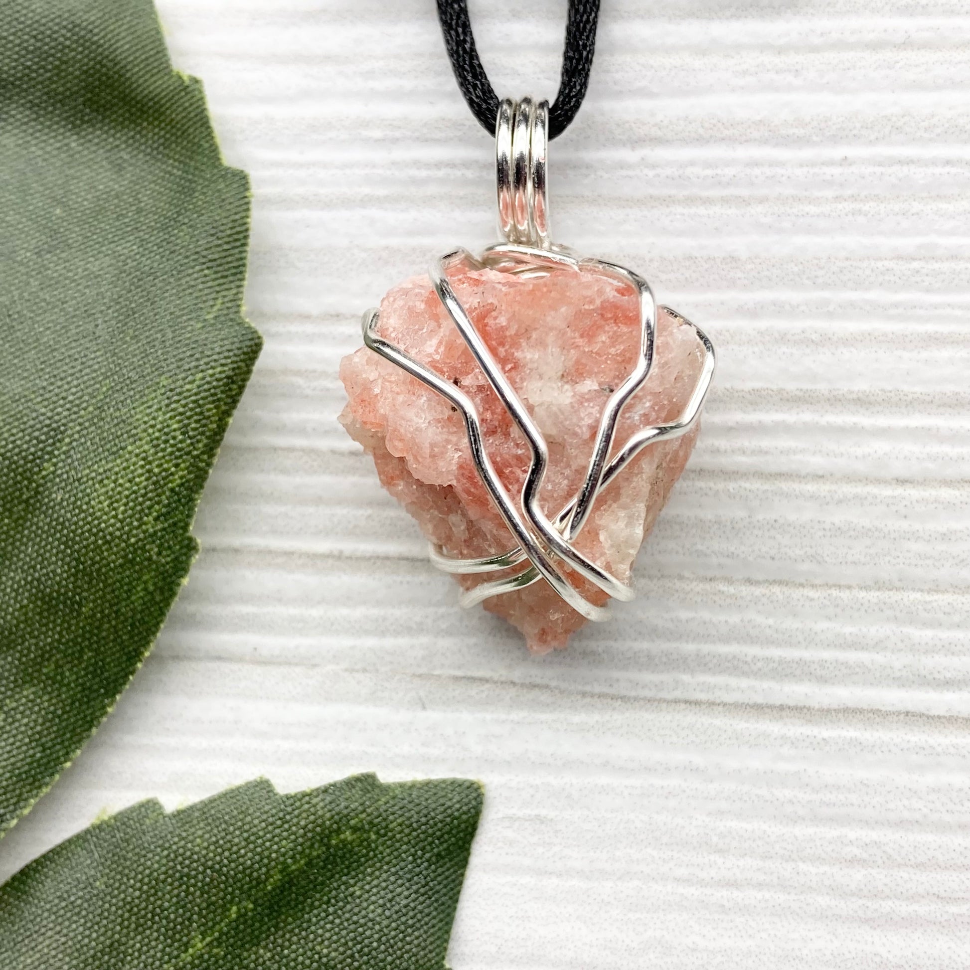 Sunstone Necklace. Raw Sunstone wrapped with silver copper wire. Comes on a black chain. Wire wrapped crystal pendant. Peachy stone jewelry.