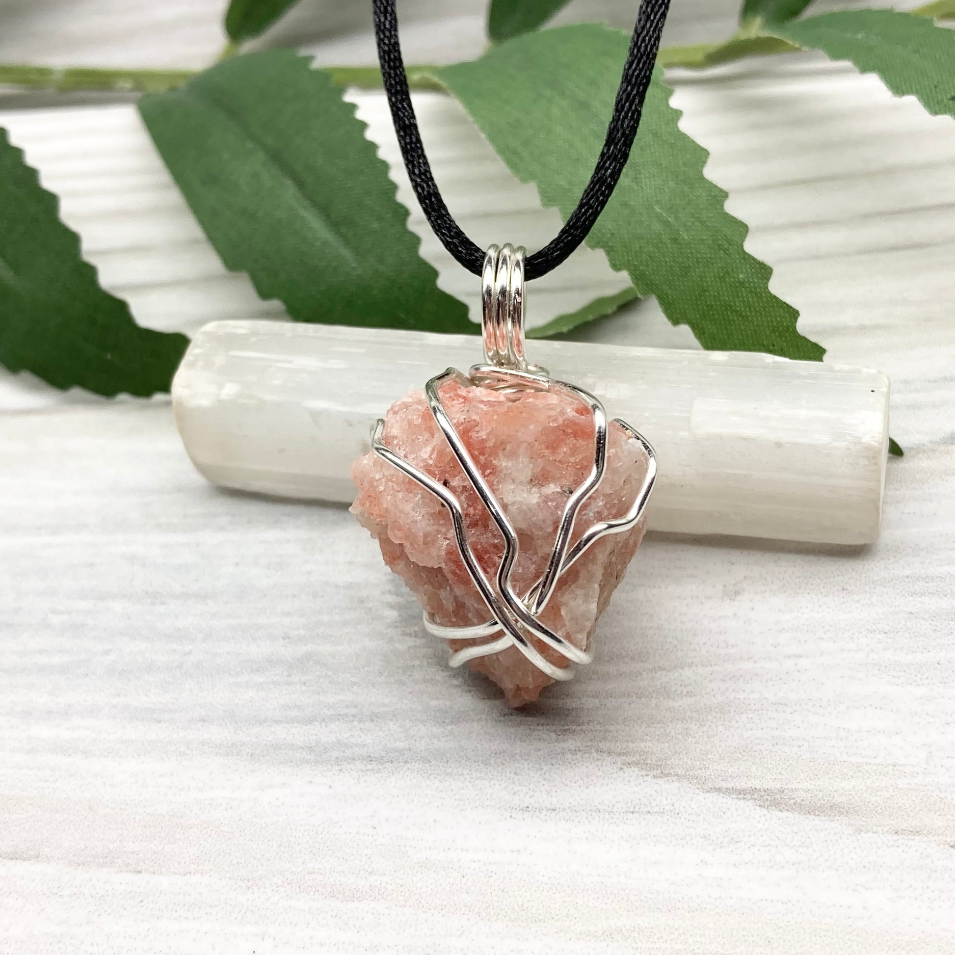 Sunstone Necklace. Raw Sunstone wrapped with silver copper wire. Comes on a black chain. Wire wrapped crystal pendant. Peachy stone jewelry.