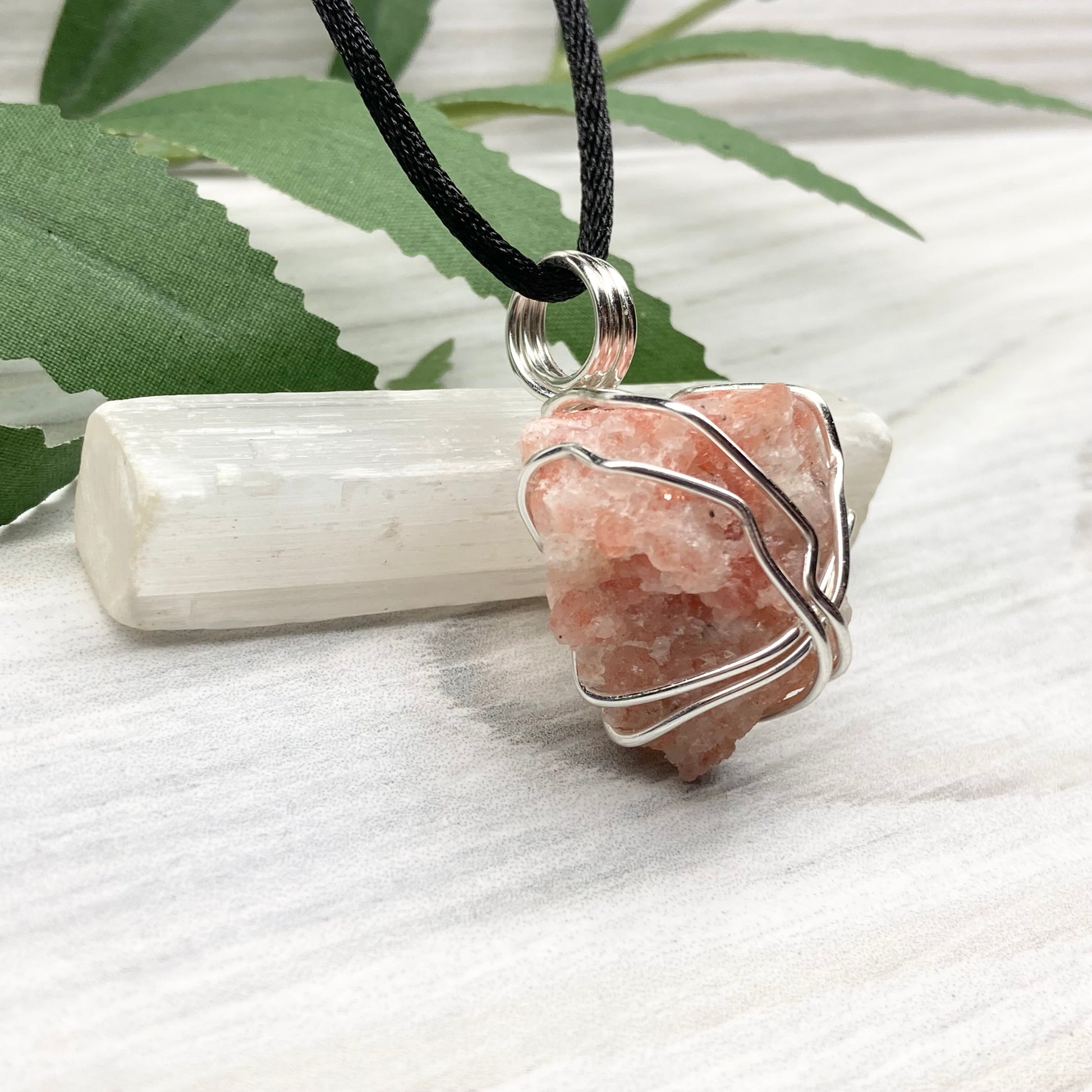 Sunstone Necklace. Raw Sunstone wrapped with silver copper wire. Comes on a black chain. Wire wrapped crystal pendant. Peachy stone jewelry.