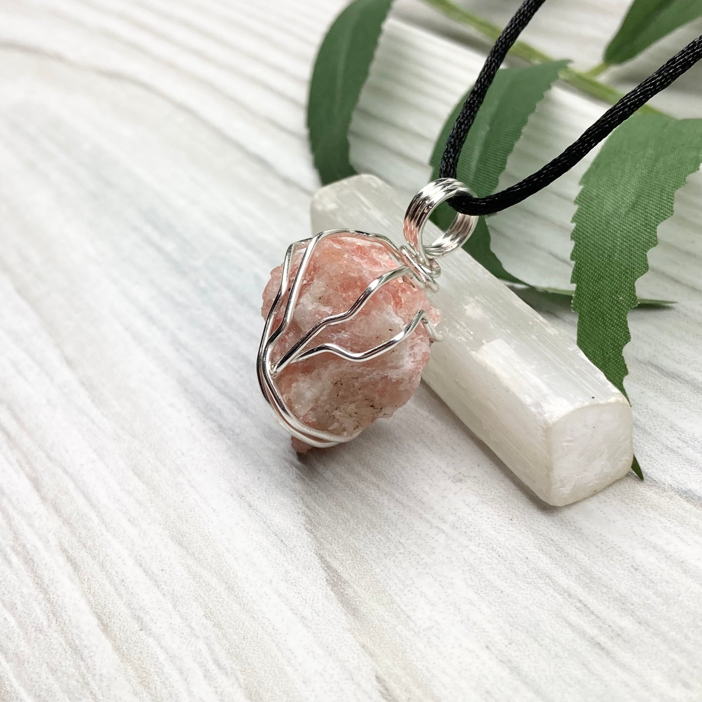 Sunstone Necklace. Raw Sunstone wrapped with silver copper wire. Comes on a black chain. Wire wrapped crystal pendant. Peachy stone jewelry.