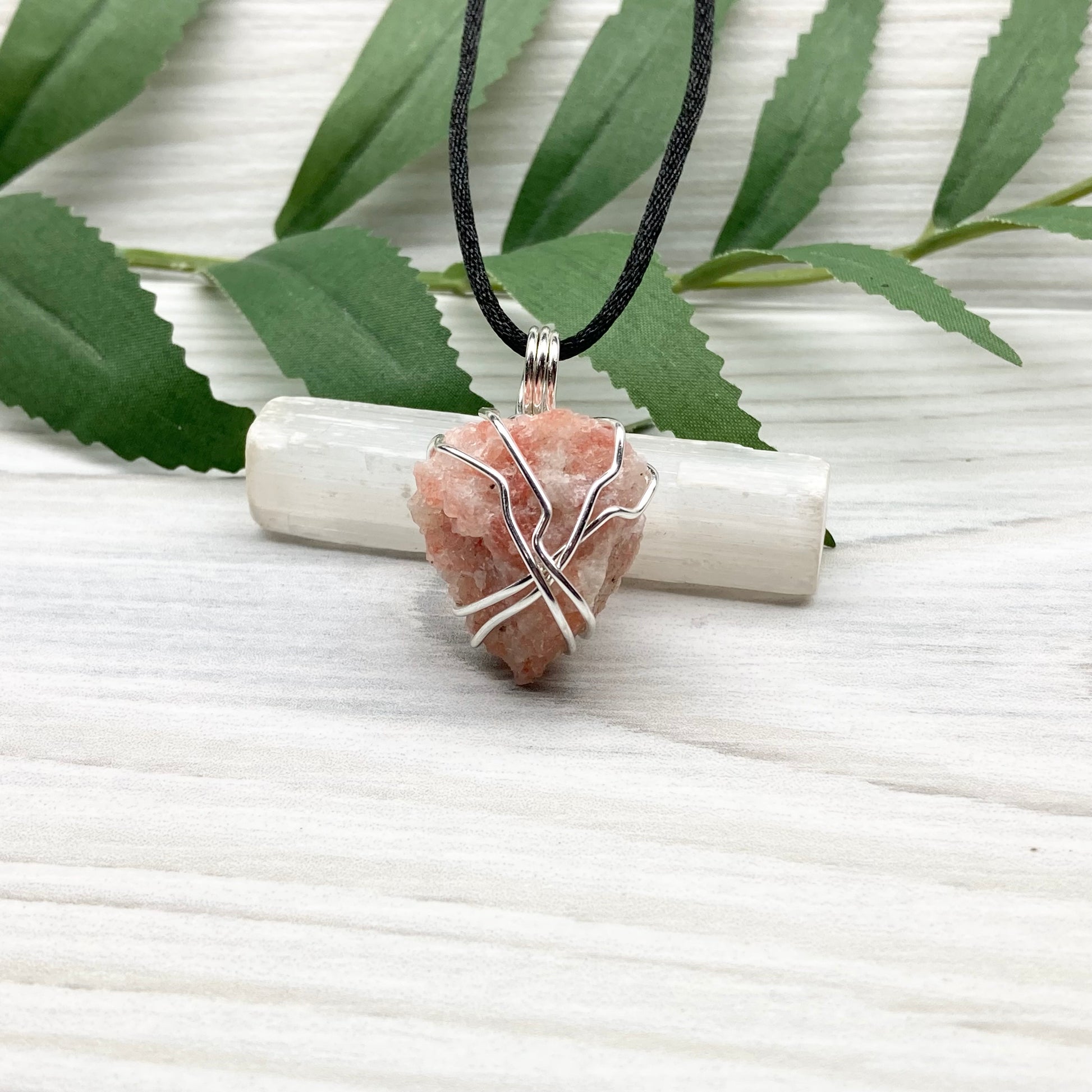 Sunstone Necklace. Raw Sunstone wrapped with silver copper wire. Comes on a black chain. Wire wrapped crystal pendant. Peachy stone jewelry.