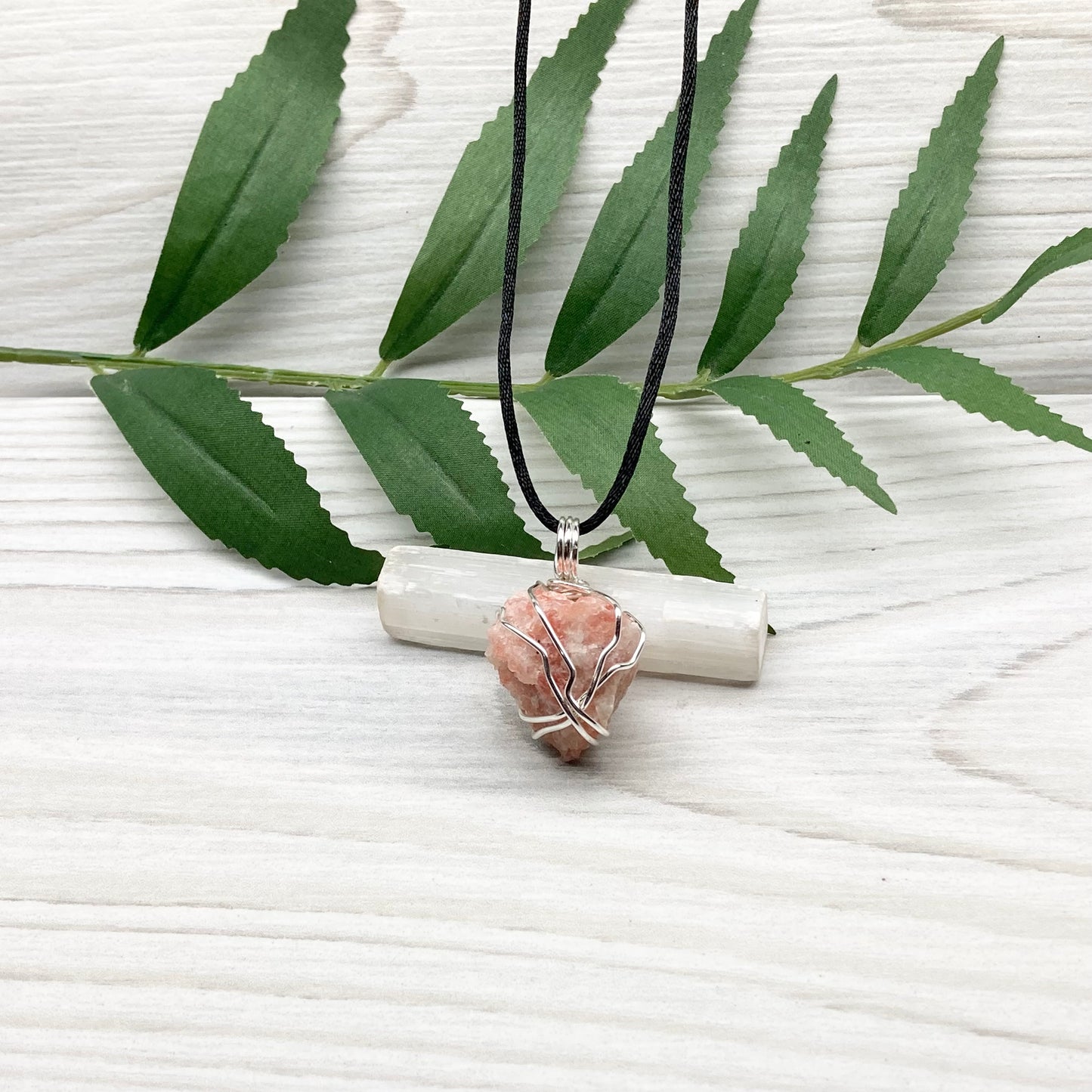 Sunstone Necklace. Raw Sunstone wrapped with silver copper wire. Comes on a black chain. Wire wrapped crystal pendant. Peachy stone jewelry.