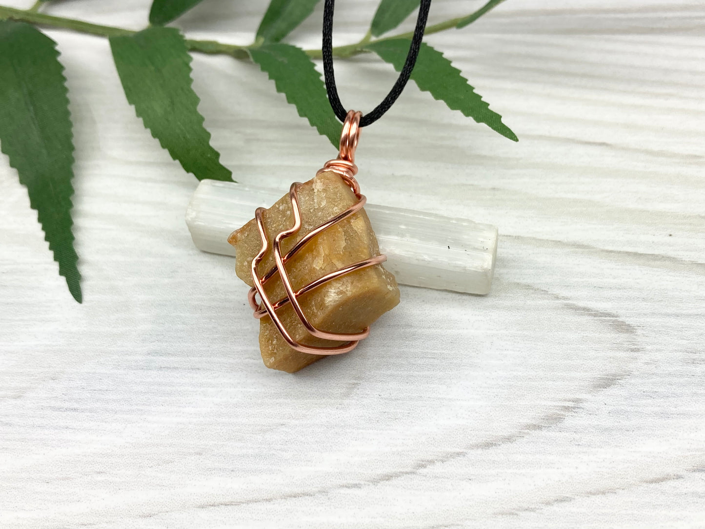 Yellow aventurine necklace. Yellow raw stone wrapped with copper wire. Comes on a black necklace. Handcrafted new age jewelry.