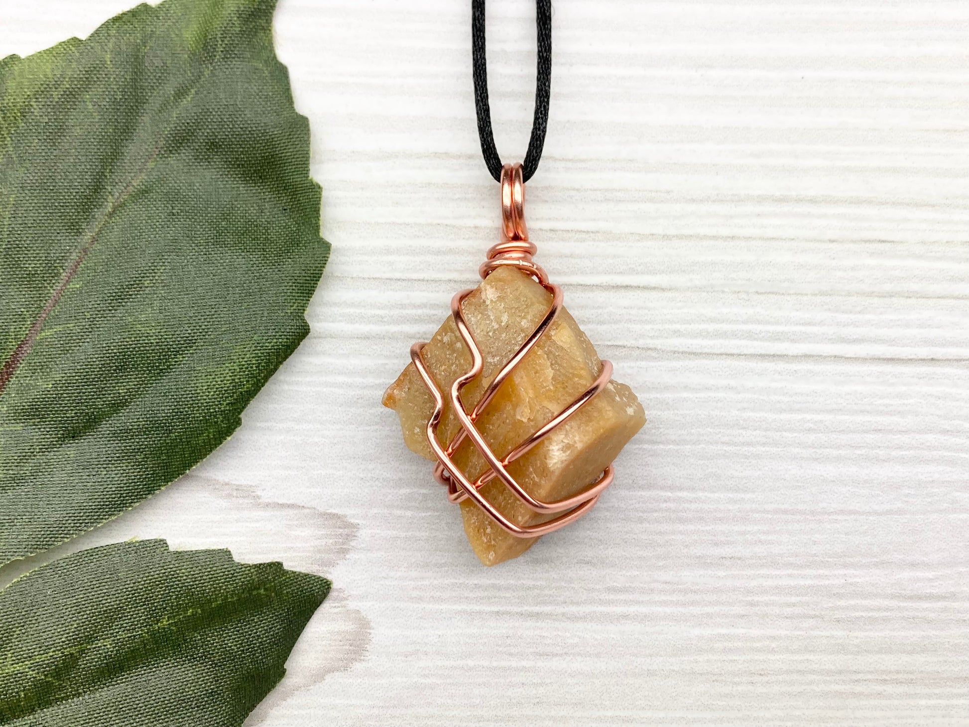 Yellow aventurine necklace. Yellow raw stone wrapped with copper wire. Comes on a black necklace. Handcrafted new age jewelry.
