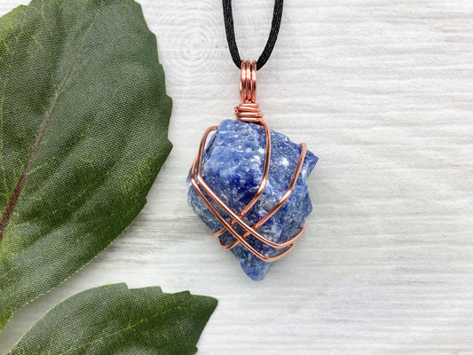 Raw Sodalite Necklace. Real Sodalite Crystal Hand Wrapped With Pure Copper Wire. Gemstone Is Blue With White In It. Comes On A Black Chain. Sagittarius Zodiac Stone Unisex Jewelry.