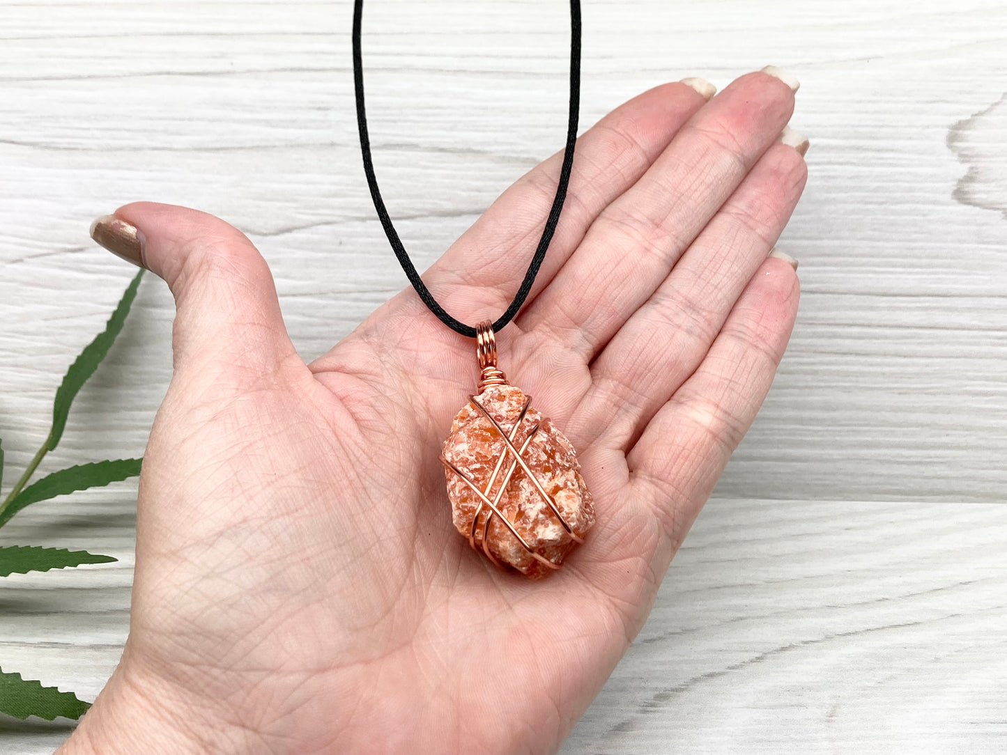 Raw Orange Calcite Necklace. Natural Orange Crystal Hand Wrapped With Copper Wire. Comes On A Black Chain. Leo Zodiac Stone Pendant. New Age Metaphysical Jewelry. Fire Element Gemstone. Pendant 1.9 X 1 Inch In Size.