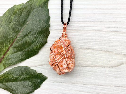 Raw Orange Calcite Necklace. Natural Orange Crystal Hand Wrapped With Copper Wire. Comes On A Black Chain. Leo Zodiac Stone Pendant. New Age Metaphysical Jewelry. Fire Element Gemstone. Free Shipping $35 And Over.