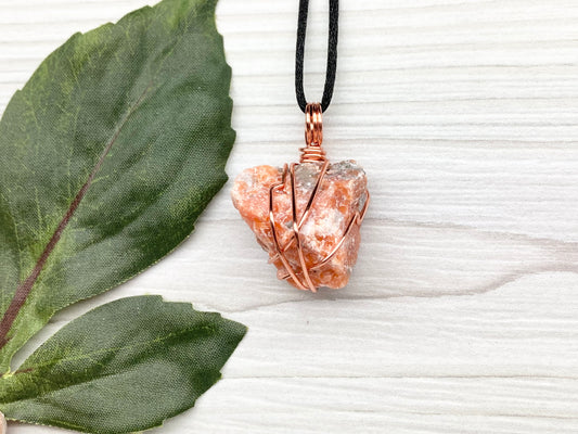 Natural Raw Orange Calcite Crystal Hand Wrapped With Tarnish Resistant Copper Wire. Comes On A Black Chain. Crystal Is Orange With A Bit Of Blue On The Top.Pendant Handcrafted During The Moon In Sagittarius. New Age Style Jewelry.