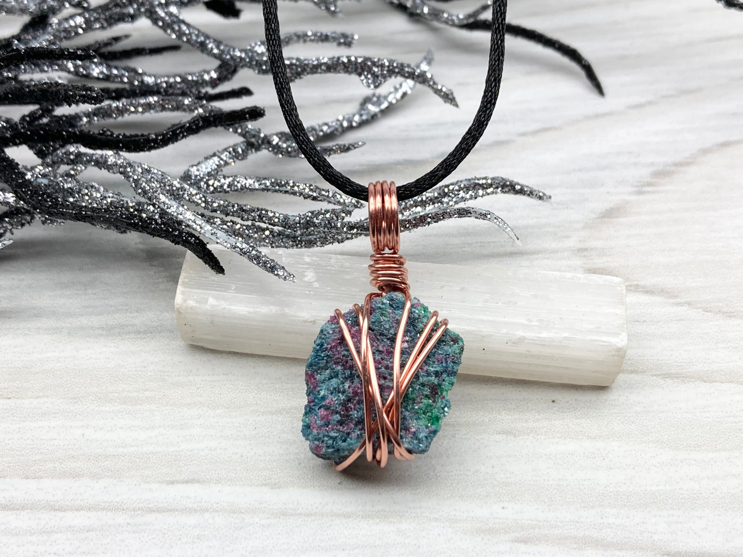 Real Raw Ruby Zoisite Necklace. This Ruby Zoisite Crystal Is Hand Wrapped With Pure Copper Wire. This Stone is Blue, Green and Red Colored. Gemstone Comes On A Black Chain. Boho Spiritual Style Unisex Jewelry.