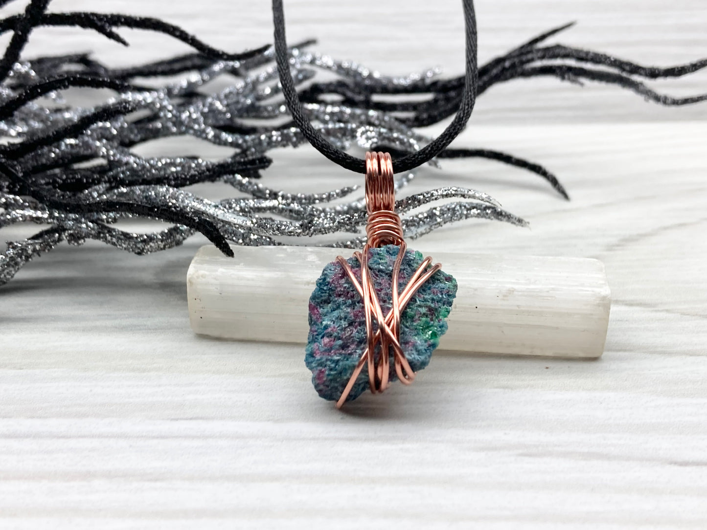 Real Raw Ruby Zoisite Necklace. This Ruby Zoisite Crystal Is Hand Wrapped With Pure Copper Wire. This Stone is Blue, Green and Red Colored. Gemstone Comes On A Black Chain. Boho Spiritual Style Unisex Jewelry.