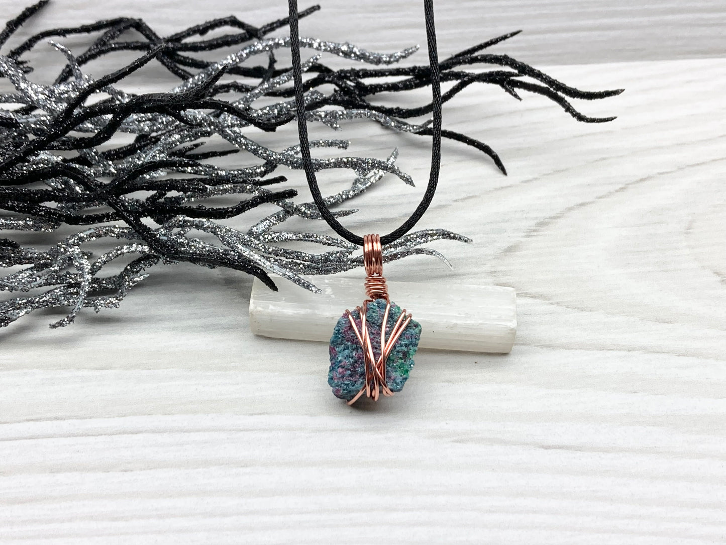 Real Raw Ruby Zoisite Necklace. This Ruby Zoisite Crystal Is Hand Wrapped With Pure Copper Wire. This Stone is Blue, Green and Red Colored. Gemstone Comes On A Black Chain. Boho Spiritual Style Unisex Jewelry.