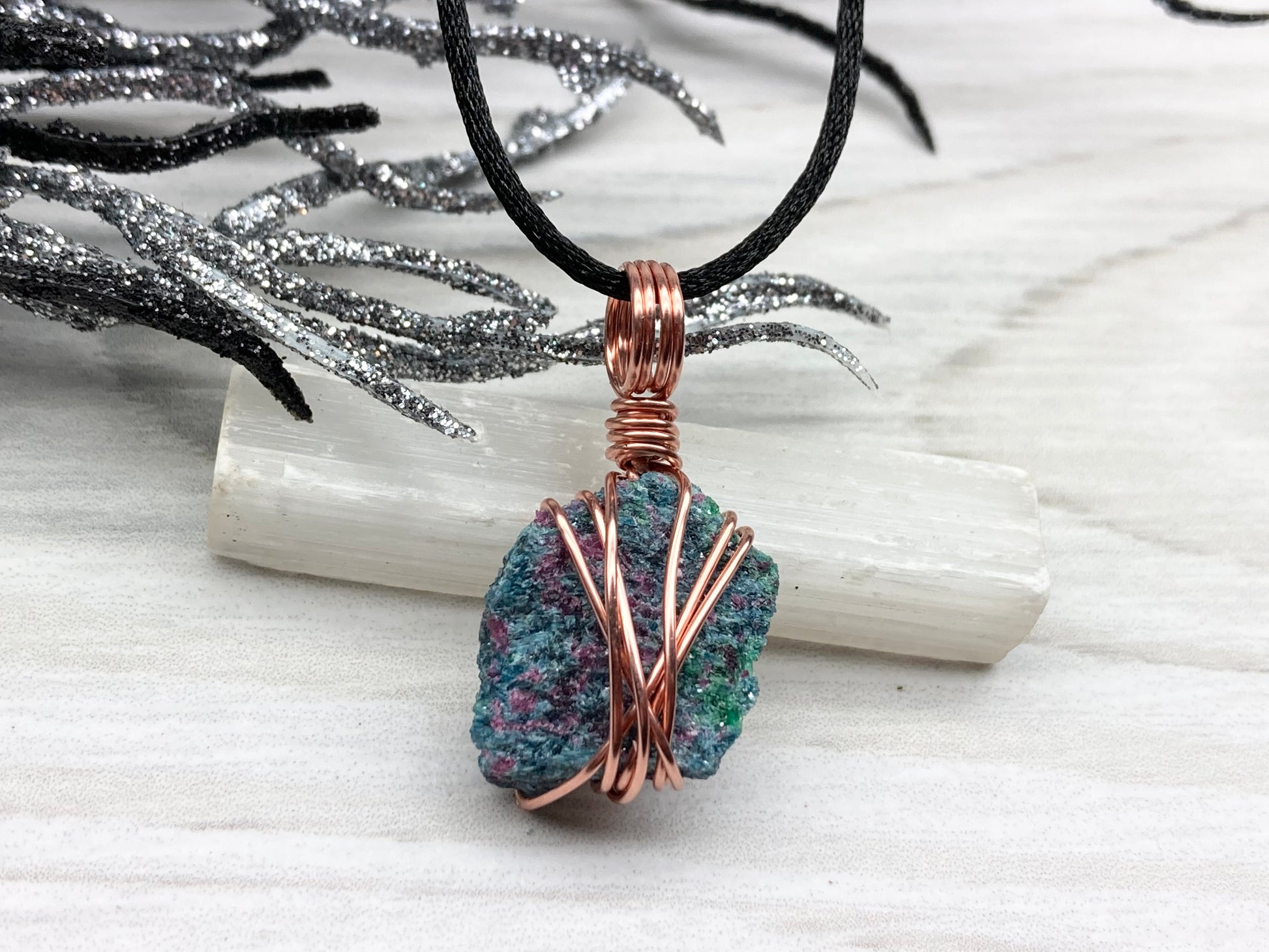 Real Raw Ruby Zoisite Necklace. This Ruby Zoisite Crystal Is Hand Wrapped With Pure Copper Wire. This Stone is Blue, Green and Red Colored. Gemstone Comes On A Black Chain. Boho Spiritual Style Unisex Jewelry.