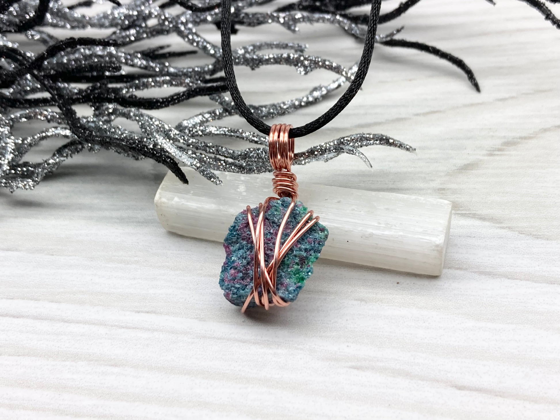 Real Raw Ruby Zoisite Necklace. This Ruby Zoisite Crystal Is Hand Wrapped With Pure Copper Wire. This Stone is Blue, Green and Red Colored. Gemstone Comes On A Black Chain. Boho Spiritual Style Unisex Jewelry.