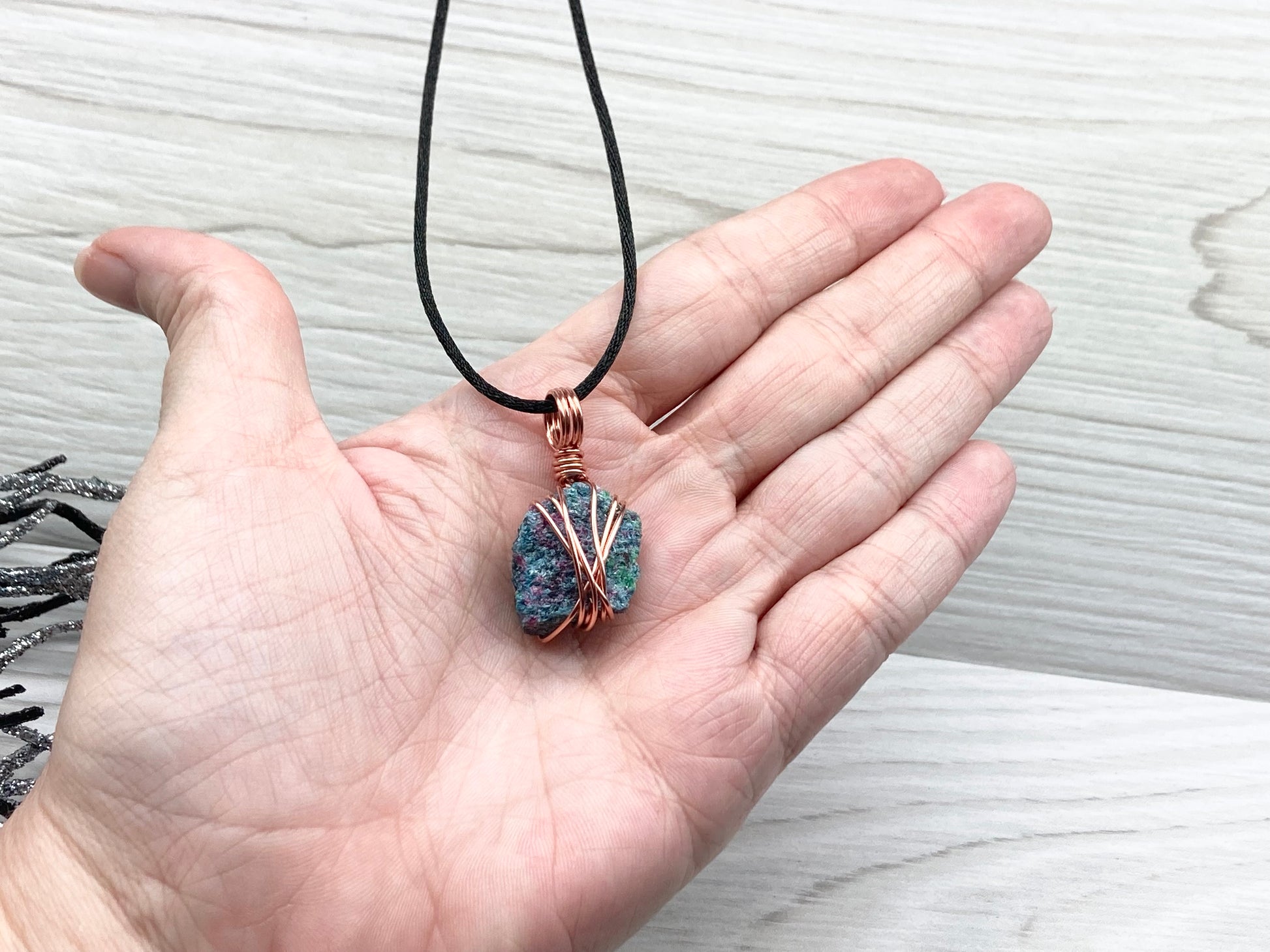 Real Raw Ruby Zoisite Necklace. This Ruby Zoisite Crystal Is Hand Wrapped With Pure Copper Wire. This Stone is Blue, Green and Red Colored. Gemstone Comes On A Black Chain. Boho Spiritual Style Unisex Jewelry.