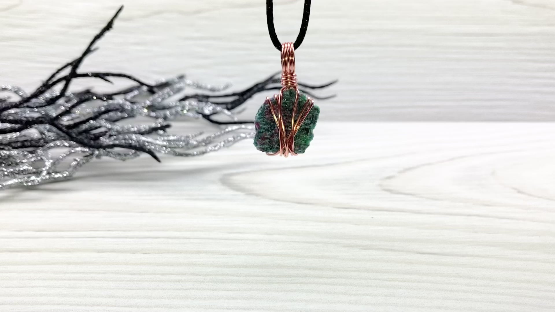 Real Raw Ruby Zoisite Necklace. This Ruby Zoisite Crystal Is Hand Wrapped With Pure Copper Wire. This Stone is Blue, Green and Red Colored. Gemstone Comes On A Black Chain. Boho Spiritual Style Unisex Jewelry. Video Shows Pendant Spinning Around.